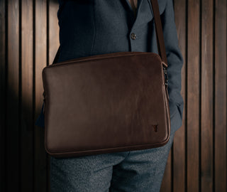 Man carrying the Dark Brown Leather Messenger Bag