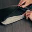 Fold over wool slap to protect your laptop on the Large All Black Leather Laptop Sleeve