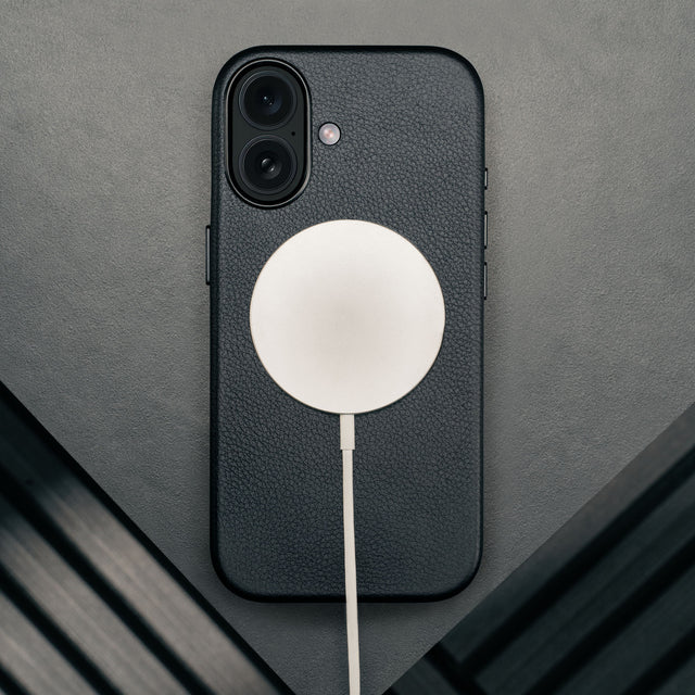 MagSafe charger attached to the Black Leather Bumper Case for iPhone 17