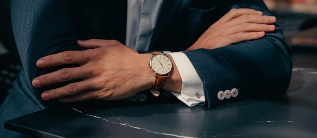 Man in suit watching a traditional dress wristwatch with TORRO Tan Leather strap