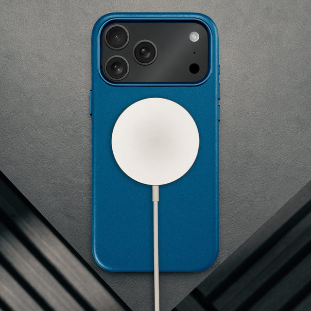 MagSafe charger attached to the Slimline Cobalt Blue Leather Bumper Case for iPhone 17 Pro