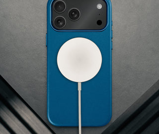 MagSafe charger attached to the Slimline Cobalt Blue Leather Bumper Case for iPhone 17 Pro