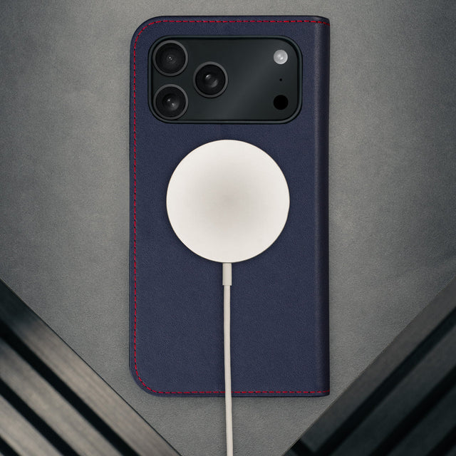 MagSafe charger attached to the Navy Blue Leather Case for iPhone 17 Pro