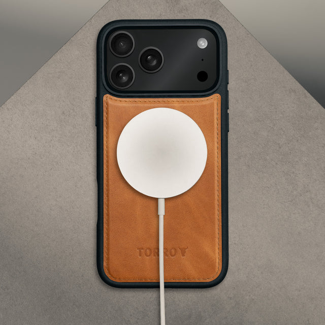 MagSafe charger attached to the bumper case from the Dark Cherry Leather Detachable Case for iPhone 17 Pro Max