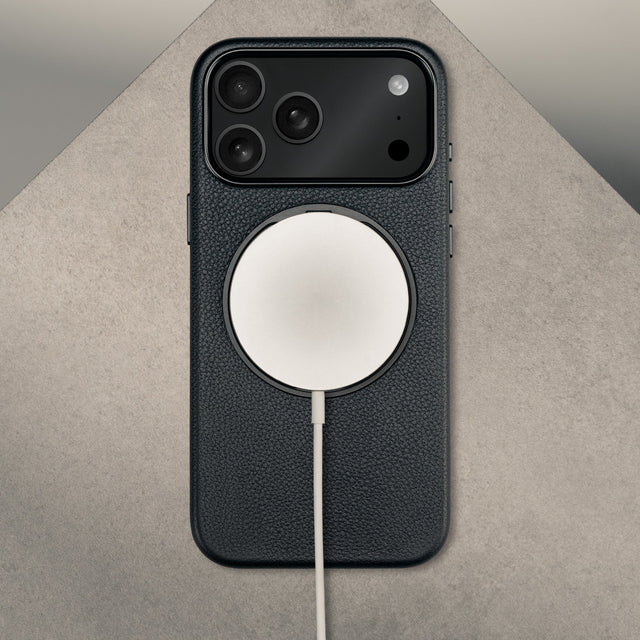 MagSafe charger attached to the Black Leather Bumper Case with Rotating Stand for iPhone 17 Pro