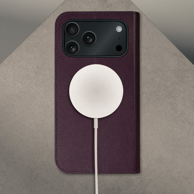 MagSafe charger attached to the Dark Cherry Leather Case for iPhone 17 Pro