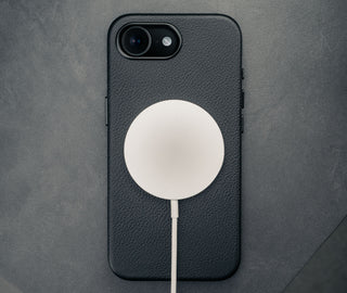 MagSafe charger attached to the Black Slimline Leather Bumper Case for iPhone SE4 (2025)