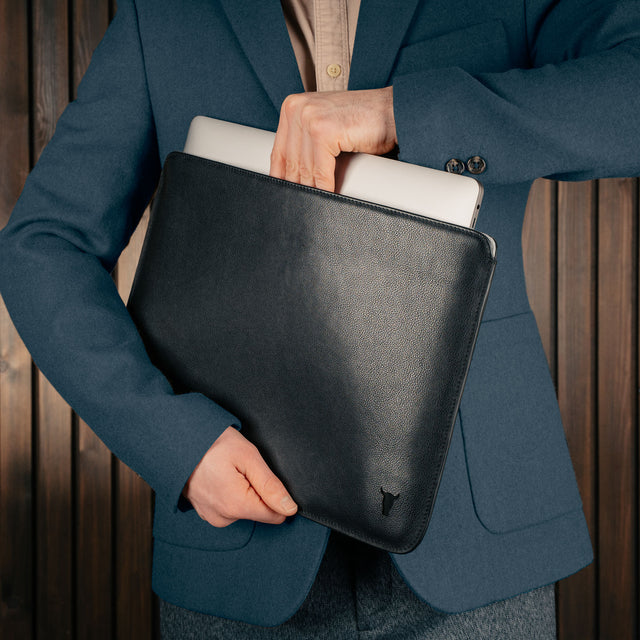 Man taking a laptop out of the Black Leather MacBook Pro / MacBook Air Sleeve