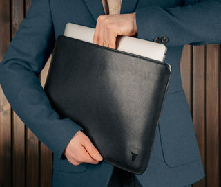 Man taking a laptop out of the Black Leather MacBook Pro / MacBook Air Sleeve